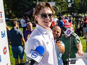 Montreal Canadiens winger Cole Caufield laughs with reporters prior to the team's annual golf tournament in Laval on Sept. 12, 2022.
