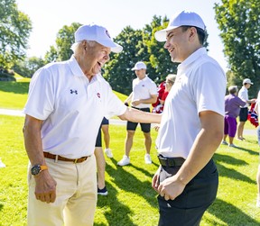Hockey Hall of Famer and former Montreal Canadiens captain Yvan Cournoyer laughs with newly named Habs captain Nick Suzuki at the team's annual golf tournament in Lava on Sept. 12, 2022.