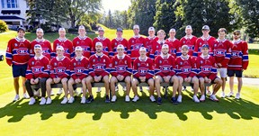 New Montreal Canadiens captain Nick Suzuki is flanked by assistant captains Joel Edmondson, left, and Brendan Gallagher while sitting for a team photo at the team's annual golf tournament in Laval on Sept. 12, 2022.