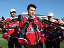 Nick Suzuki addresses reporters after being named the new captain of the Montreal Canadiens at the team's annual golf tournament in Laval, north of Montreal on Monday, September 12, 2022. He is joined by co-captain Joel Edmondson, left and Brendan Gallagher.