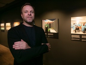 Photographer Michel Huneault with his photographs of the COVID-19 pandemic at the McCord Stewart Museum on Wednesday Sept. 14, 2022.