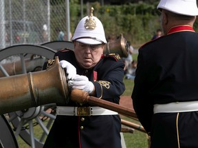 Thomas Savoie of the Westmount Battery loads gunpowder into the bronze cannon during a ceremony held at the Westmount Athletic Grounds to commemorate Queen Elizabeth II, on Saturday Sept. 17, 2022.