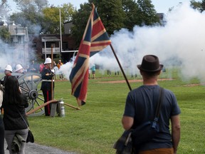 Thomas Lapierre holds the Union Jack during the firing of a bronze cannon of the Westmount Battery during a ceremony held at the Westmount Athletic Grounds to commemorate Queen Elizabeth II, on Saturday Sept. 17, 2022.