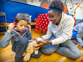 First-year McGill nursing student Christleen Elysée helps Sebastian Rodriguez Chaparro listen to his teddy bear's heart during a teddy bear hospital event at Hampstead Elementary School on Friday Sept. 16, 2022.