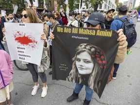 Demonstrators march on René-Lévesque Blvd. in Montreal on Wednesday, Sept. 21, 2022 in support of Mahsa Amini, a woman who died in police custody in Iran after her arrest for not wearing her hijab correctly.
