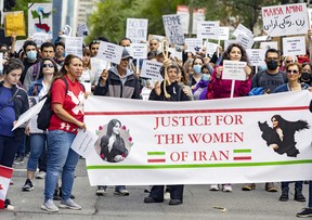 Demonstrators march on René-Lévesque Blvd. in Montreal Wednesday, Sept. 21, 2022 in support of Mahsa Amini, the Iranian woman who died in police custody in Iran after her arrest for not wearing her hijab correctly.