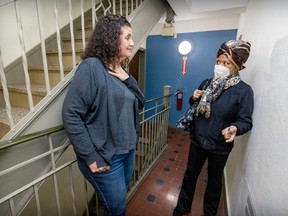 Elana Hersh (left), who has fought against renovictions, speaks with neighbour Rosalind Smith in the hallway of their apartment building in Hampstead.