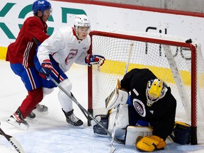 Montreal Canadiens' Jordan Harris gets shoved in to the net during the final practice of rookie camp in Montreal on Sept. 20, 2022.