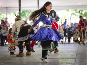 Kwena Bellemare-Boivin, a member of the Atikamekw nation from Wemotaci, Quebec, dances the traditional Iroquois Stick dance during McGill's 21st Annual Pow Wow in Montreal  on Friday, Sept. 23, 2022.