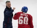 Canadiens head coach Martin St-Louis greets Alex Belzile during first day of training camp at Brossard on Thursday.