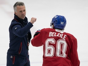 Canadiens head coach Martin St-Louis greets Alex Belzile during first day of training camp in Brossard on Thursday.