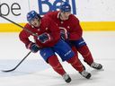 Montreal Canadiens' Juraj Slafkovsky, rear, goes through drill with Ryan Francis during first day of training camp in Brossard on Sept. 22, 2022.