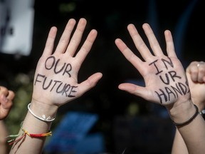 A participant in a climate protest in Montreal on Friday September 24, 2021 displays a message.