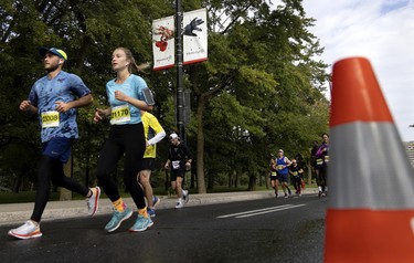 Runners enter the final stretch along Sherbrooke St. during the Montreal marathon on Sept. 25, 2022.
