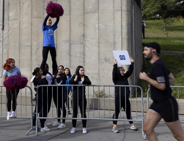 Cheerleaders from College de Maisonneuve encourage runners during the Montreal marathon on Sept. 25, 2022.