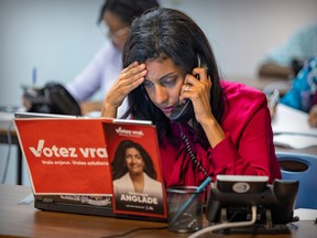 Quebec Liberal Party Leader Dominique Anglade phones voters during a visit to her riding office in the Saint-Henri district of Montreal Sept. 25, 2022.