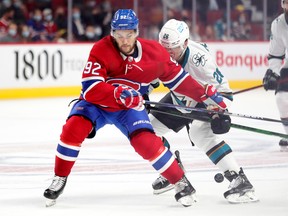 Montreal Canadiens' Jonathan Drouin fights for loose puck with San Jose Sharks Jasper Weatherby during second period in Montreal on Oct. 19, 2021.