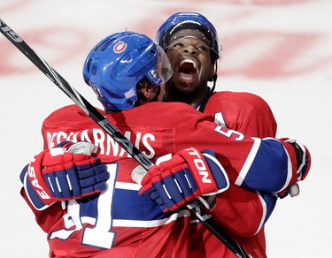 David Desharnais and P.K. Subban of the Montreal Canadiens celebrate Desharnais's overtime-winning goal against the Detroit Red Wings at the Bell Centre on Oct. 21, 2014.