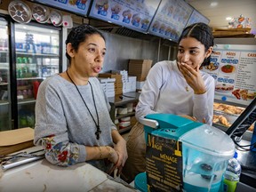 Angil Nekoula, with daughter Myriam Josef, says she has started to close her restaurant earlier at night because the area is "not safe anymore." But her main concern, she says, is the increased cost of running her business.