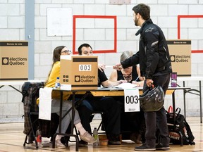 A man casts his ballot at a polling station in the provincial elections on October 1, 2018 in Montreal, Quebec.