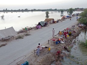 This aerial photograph taken on September 5, 2022 shows the makeshift tents of internally displaced flood-affected people after heavy monsoon rains at Dera Allah Yar town in Jaffarabad district of Balochistan province. - Nearly a third of Pakistan is under water -- an area the size of the United Kingdom -- following months of record monsoon rains that have killed 1,300 people and washed away homes, businesses, roads and bridges. (Photo by Fida HUSSAIN / AFP)