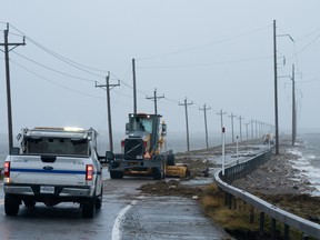 Highway crews clean debris caused by tropical storm Fiona on Îles-de-la-Madeleine.