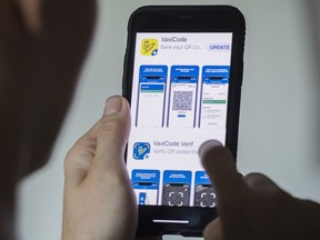 A person looks at the Quebec government's vaccine passport app called VaxiCode.