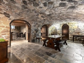 The basement of this Dorval castle has old masonry stone walls and ceilings of stone and wood planks.