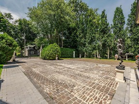 A statue greets visitors in the driveway of this Dorval castle.