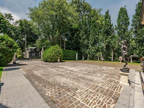 A statue greets visitors in the driveway of this Dorval castle.