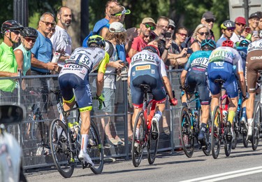 Fans watch as riders in the Grand Prix Cyclistes race speed by in Montreal on Sept. 11, 2022.