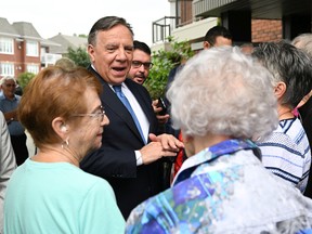 Coalition Avenir Quebec Leader Francois Legault speaks with seniors during a campaign stop at a senior residence, Tuesday, August 30, 2022 in St-Georges Quebec. Quebecers are going to the polls for a general election on Oct. 3.