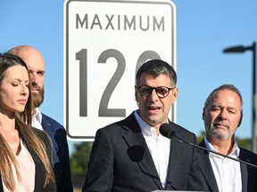 Quebec Conservative Leader Éric Duhaime, flanked by local candidates and a mocked-up sign, proposes to raise the speed limit to 120 km/h on highways, Saturday, Sept. 17, 2022, in Lévis.
