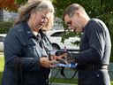 Conservative Party of Quebec Leader Éric Duhaime signs his biography for a supporter after a morning run on the Plains of Abraham, Thursday, September 29, 2022 in Quebec City.