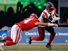 Montreal Alouettes rusher Jeshrun Antwi gets past Calgary Stampeders linebacker Cameron Judge during second half in Calgary on June 9, 2022.