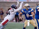 Montreal Alouettes defensive lineman Mike Moore throws himself at Winnipeg Blue Bombers quarterback Zach Collaros during first quarter in Montreal on Aug. 4, 2022.
