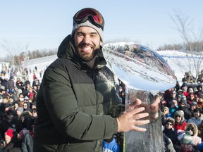 Super Bowl champion and Kansas City Chiefs player Laurent Duvernay-Tardif poses next to an ice sculpture of the Vince Lombardi Trophy during an event to celebrate his win in Montreal, Sunday, February 9, 2020. Duvernay-Tardif, who put his NFL career on hold to begin a residency program at a Montreal-area hospital to fulfil doctorate requirements, is hoping for one more football season before retiring this winter.