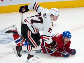 Chicago Blackhawks' Kirby Dach trips Montreal Canadiens' Laurent Dauphin during first period in Montreal on Dec. 9, 2021.