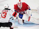 Montreal Canadiens goaltender Jake Allen stops Nico Hischier of the New Jersey Devils during the first period in Montreal on September 26, 2022.
