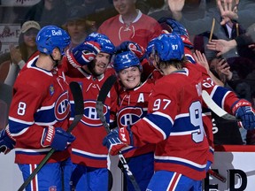 Montreal Canadiens forward Cole Caufield (22) celebrates with teammates, including defenceman Mike Matheson (8) and forward Joshua Roy (97) after scoring a goal against the New Jersey Devils during the first period at the Bell Centre in Montreal on Sept. 26, 2022.