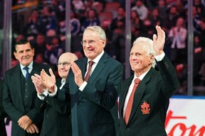 Former NHL and Team Canada player Paul Henderson salutes as teammates (from right) Ken Dryden, Ron Ellis and John Ferguson applaud him during a ceremony to honor members of the team that played in the series 1972 Summit against the Soviet Union. Serge Savard looks on (on the left). The ceremony preceded the preseason game between the Montreal Canadiens and the Toronto Maple Leafs at the Scotiabank Arena in Toronto on Wednesday, September 28, 2022.