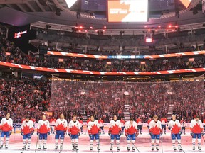The Montreal Canadiens (white jerseys) and Toronto Maple Leafs (red jerseys) wear commemorative Team Canada jerseys during a pre-game ceremony to honor the 50th anniversary of the 1972 Canada-Soviet Union hockey series, at Scotiabank Arena in Toronto on Wednesday, September 28.  , 2022.