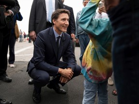 Prime Minister Justin Trudeau greets a young girl in a crowd after announcing an increase in the GST credit for low-income families in St. Andrews, N.B., on Tuesday, Sept. 13, 2022.