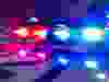 Police car lights in night time, crime scene, night patrolling the city. Abstract blurry image.
