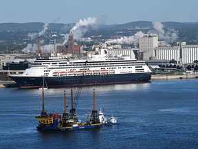 The cruise ship Zaandam is docked at the Port of Quebec, Sept. 2, 2022; a drilling rig surveys the underground for the future project of a tunnel between Lévis and Quebec City.