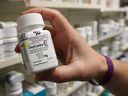 A pharmacist holds a bottle OxyContin made by Purdue Pharma at a pharmacy in Provo, Utah, US, May 9, 2019.