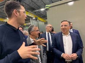 Coalition Avenir Québec leader François Legault, right, and Rouyn-Noranda-Temiscamingue candidate Andre Bernard, centre, visit a factory in Rouyn-Noranda, Que., Thursday, Sept. 29, 2022.