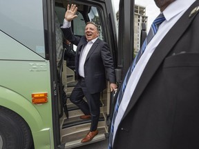 CAQ Leader François Legault waves to supporters during a campaign stop in Laval.