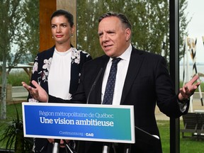 Coalition Avenir Québec Leader François Legault speaks at a news conference, Friday, September 9, 2022 in Quebec City. CAQ candidate Geneviève Guilbault, left, looks on. Quebecers are going to the polls for a general election on Oct. 3.