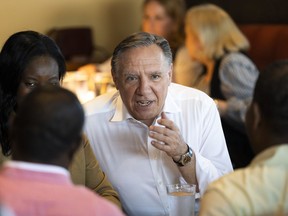 CAQ Leader François Legault chats with supporters during a luncheon in Laval on Monday, Sept. 12, 2022.